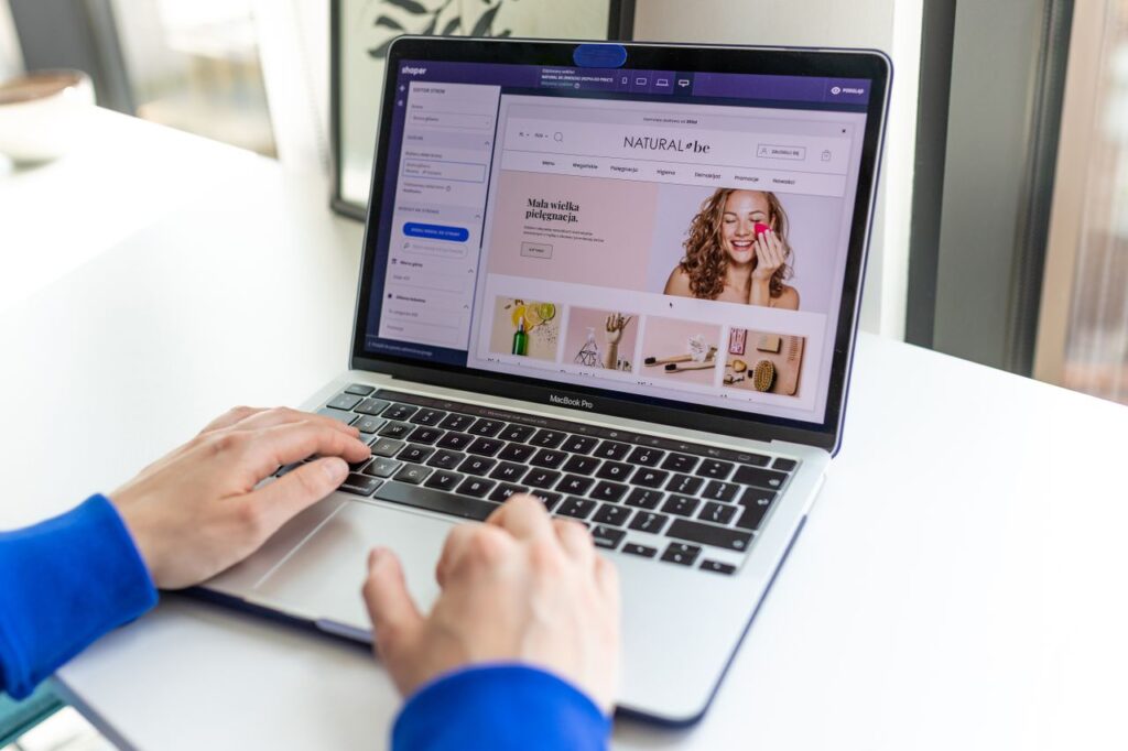 pexels photo 17485350 Hands typing on a laptop with an e-commerce website open, showcasing online shopping.